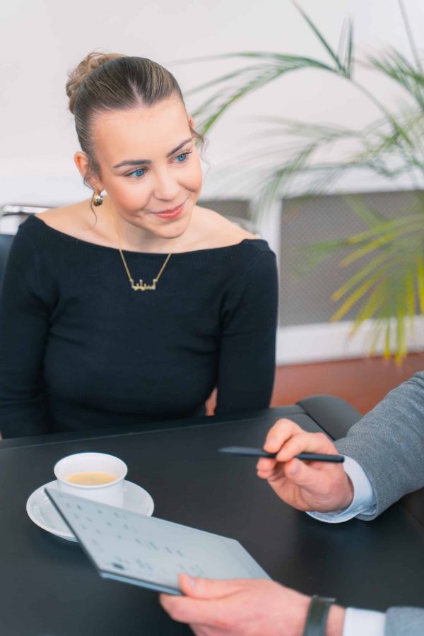 Mitarbeiterin im Meeting - Tasse Kaffee